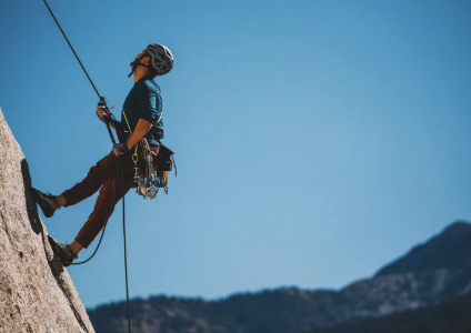 Rock climber ascending a cliff face, symbolizing growth and support